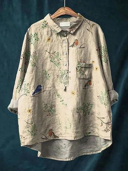 Close-up of neckline and floral print on an elegant women's blouse. Chic & comfortable long sleeve top.