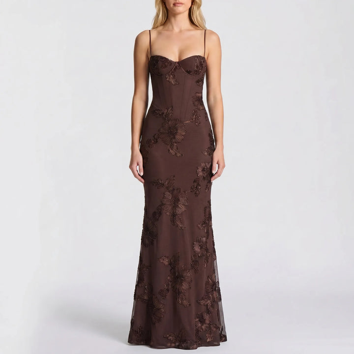 Fitted women's formal maxi gown with intricate floral appliqué & spaghetti straps for evening events.