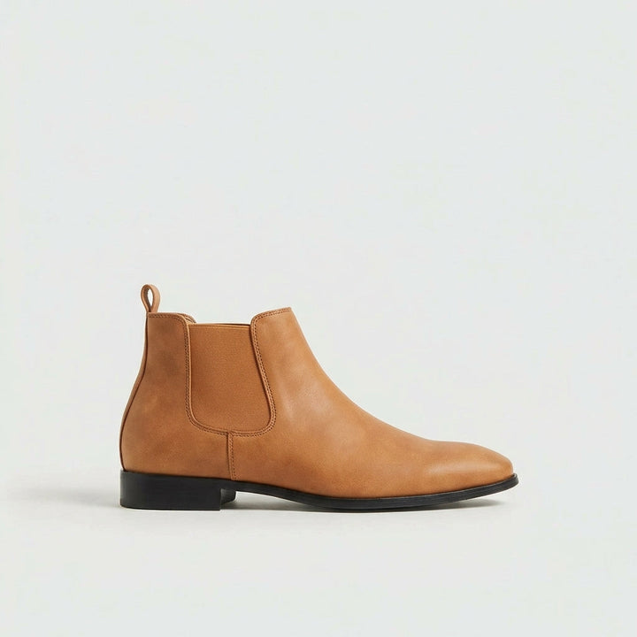 Grey stylish men's Chelsea boots. Versatile slip-on footwear designed for everyday comfort and elegance.