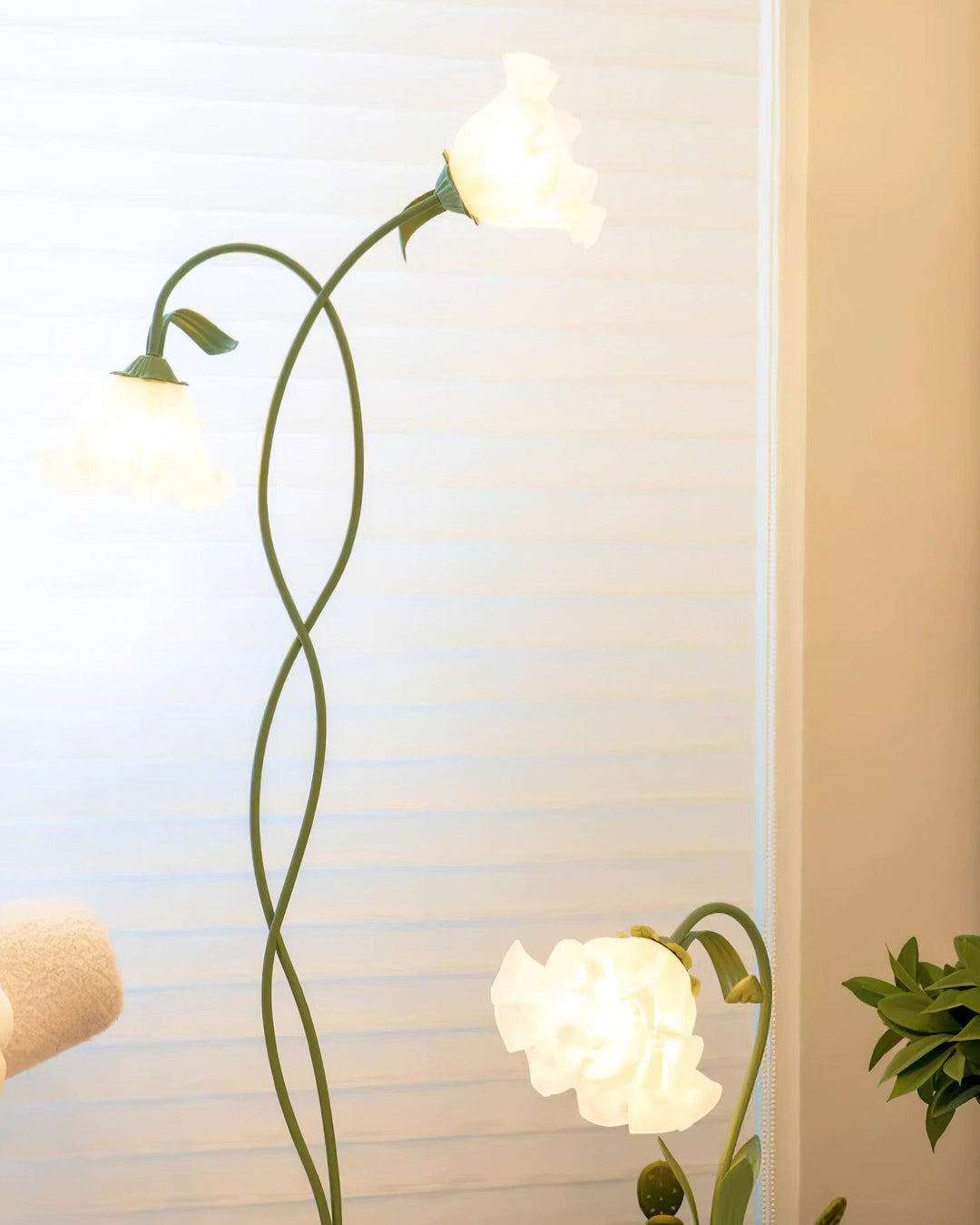 Elegant green floral floor lamp for modern interiors, white shade, ambient lighting.