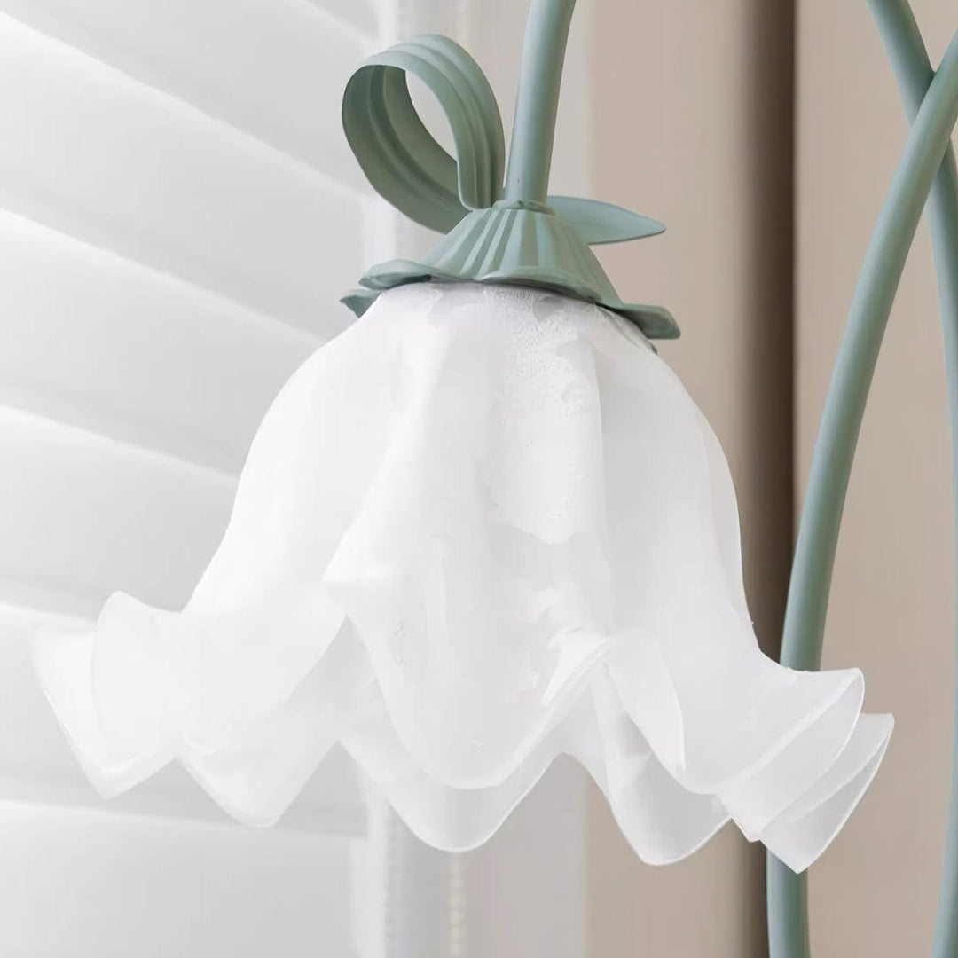 Contemporary green floral floor lamp, white shade, perfect for bedroom ambient light.