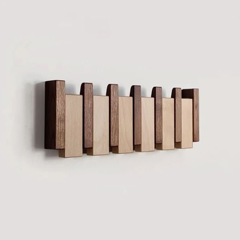 Stylish piano style wall coat rack, a space-saving storage solution with practical foldable hooks.