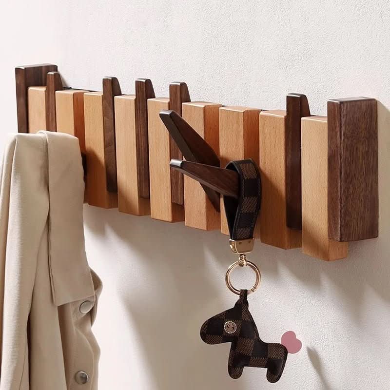 Space-saving storage solution: elegant piano design wall coat rack with practical foldable hooks.