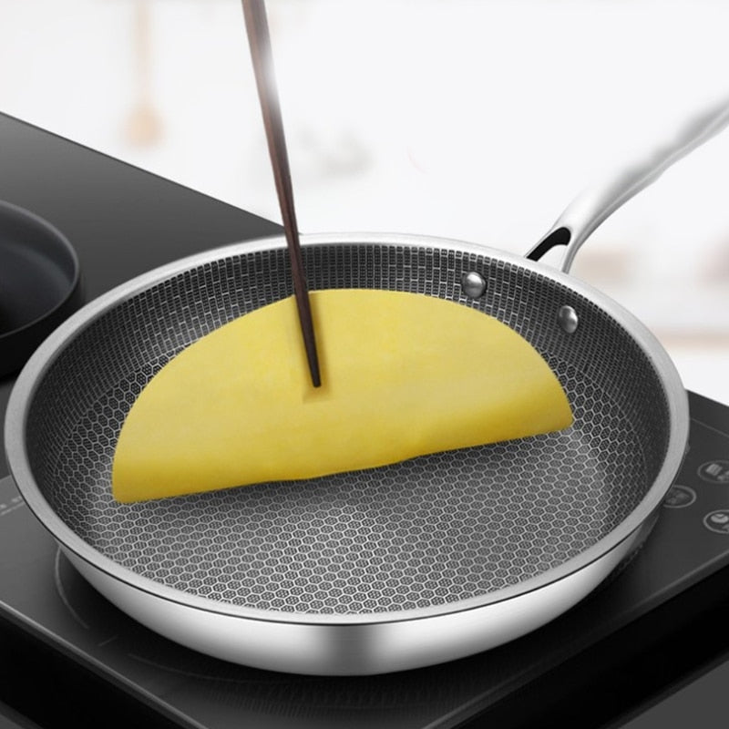 Induction-ready stainless steel frying pan. Non-stick skillet for durable kitchen cooking.