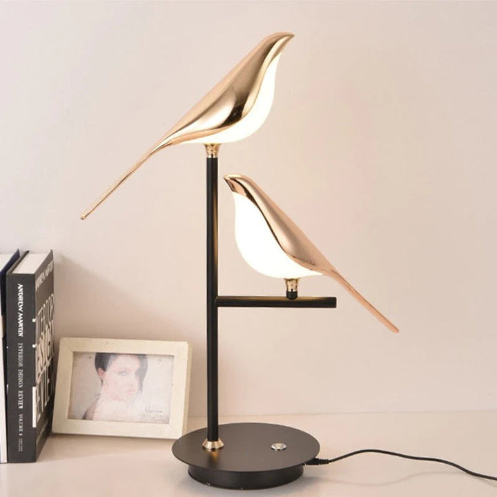 Artistic gold bird LED wall light. Scandinavian style avian lamp, perfect for modern living room decor.