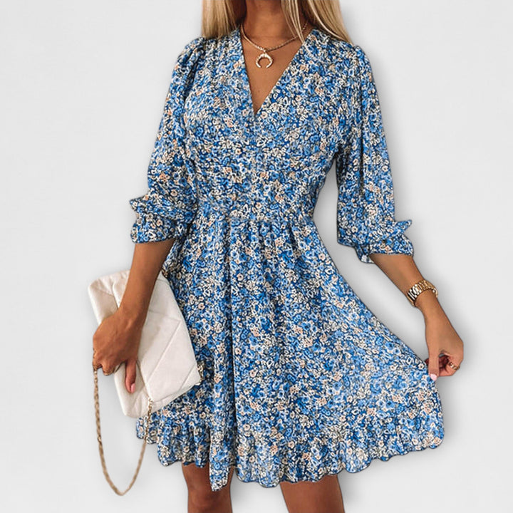 Flowy women's floral puff sleeve A-line midi dress, comfortable for summer vacation or casual spring days.