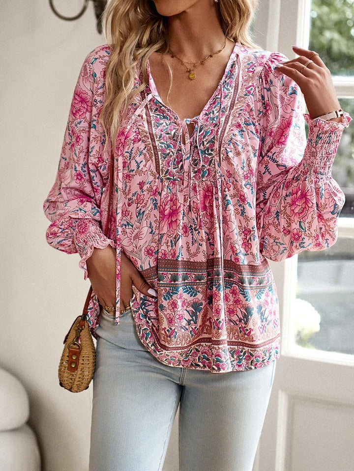 Women's elegant floral puff sleeve summer top. Lightweight and comfortable short-sleeve blouse for casual wear.