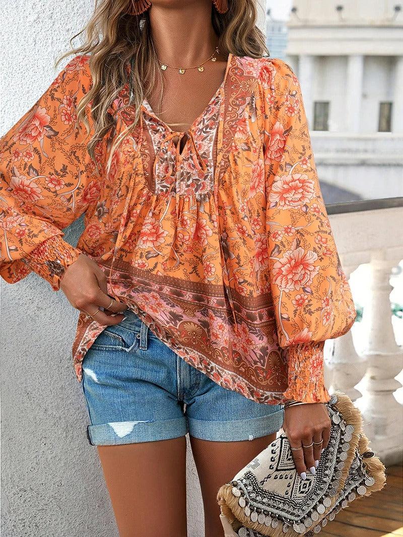Lightweight women's floral top with chic puff sleeves. A stylish and comfortable summer blouse for women.