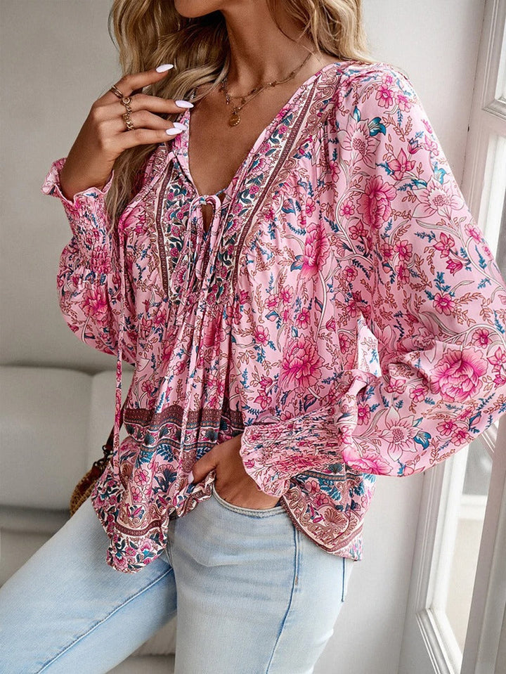 Feminine floral summer top for women, featuring comfortable fabric & stylish puff sleeves. Perfect casual wear.
