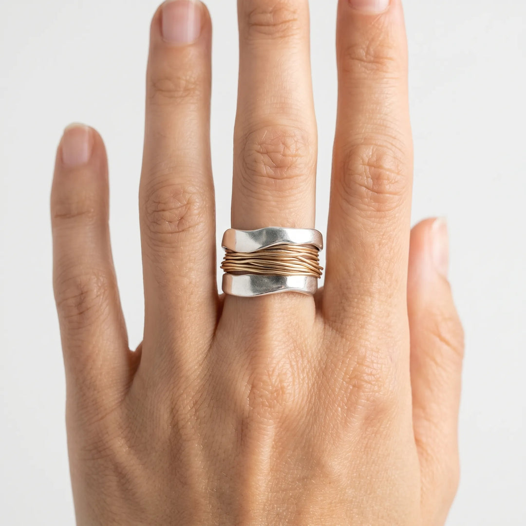 Chic minimalist women's two-tone sterling silver ring with a unique gold wire detail. Perfect modern accessory.