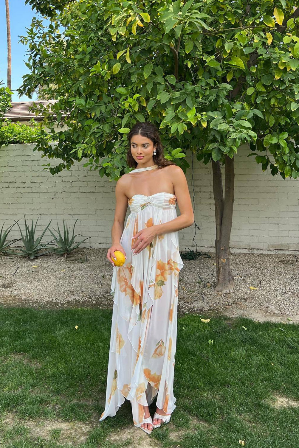 Elegant white halter maxi dress for women, perfect for summer occasions. Features a flowy silhouette and open back.