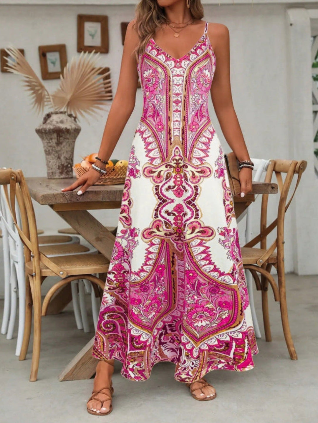 Flowy bohemian women's maxi dress featuring a V-neck and elegant paisley pattern, ideal for beach or casual wear.