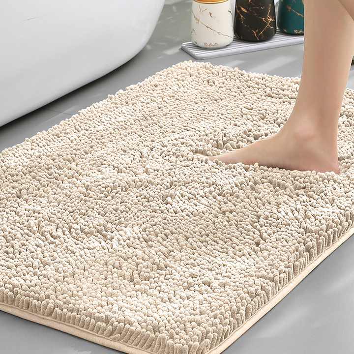Plush absorbent bath mat with secure non-slip grip backing, perfect for a safe and cozy bathroom floor.