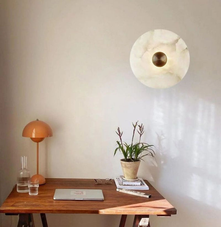Modern round brass LED flush mount wall light. Luxury alabaster sconce for interior home lighting.