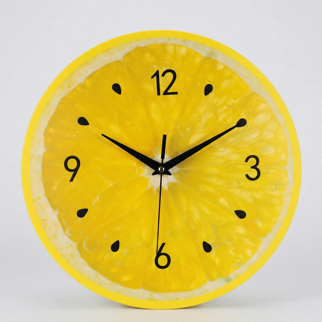 Modern round citrus wall clock for kitchen decor. Novelty yellow clock adds bright accent to any home.