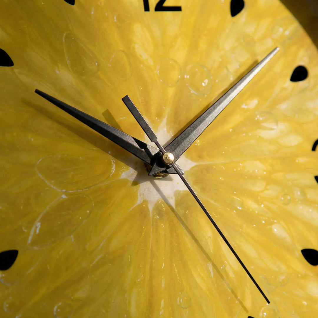 Fun round citrus wall clock with bright yellow design, ideal novelty kitchen decor. A modern home accent.