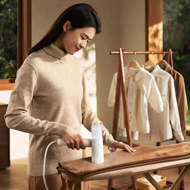 Travel-friendly Tavvitaimp18 portable fabric steamer & iron, perfect for quick wrinkle & mite removal at home or travel.