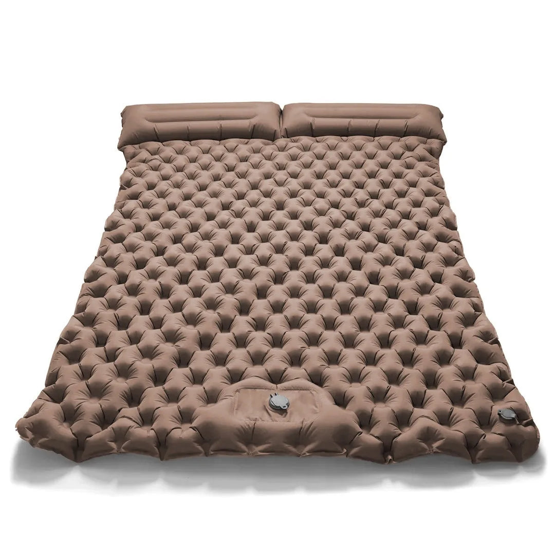 Kids playing on a dual camping air bed in the backyard. Versatile inflatable mattress, guest bed comfort.