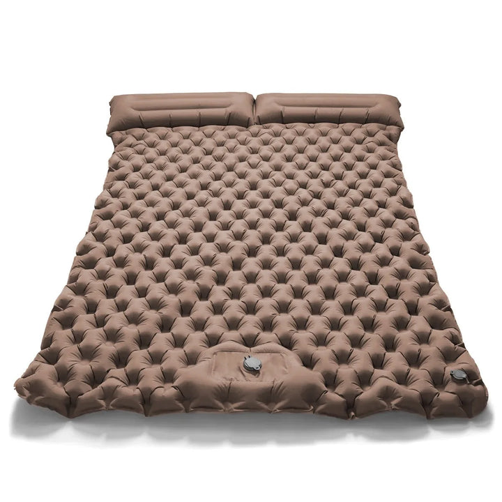 Kids playing on a dual camping air bed in the backyard. Versatile inflatable mattress, guest bed comfort.