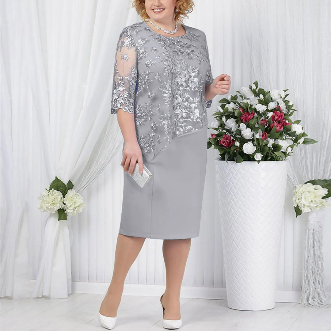 Elegant faux wrap women's midi dress with delicate lace detail, offering a flattering fit.