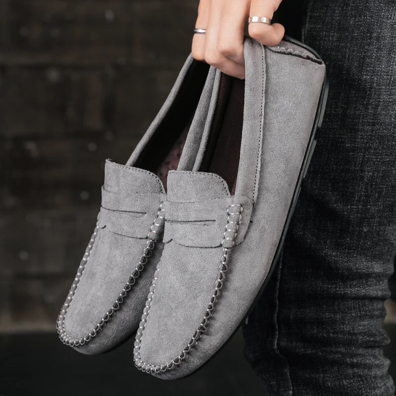 Close-up of Men's Tivoli penny loafers, showcasing the premium leather texture & meticulous stitching for durability.