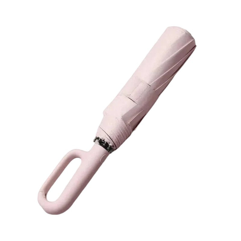 Ergonomic handle of automatic travel umbrella, comfortable grip, non-slip, built for windy conditions.