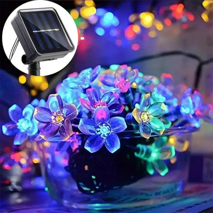 Beautiful solar LED blossom fairy lights, 16.4 ft, for magical garden & outdoor patio ambiance.