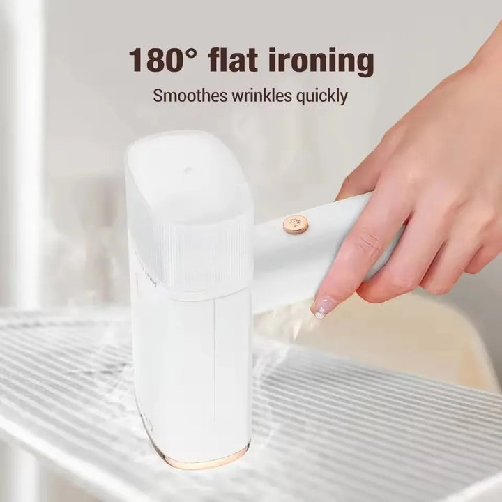 Person using a portable 1000W fabric steamer to quickly remove wrinkles from a dress. Travel-friendly clothes care.