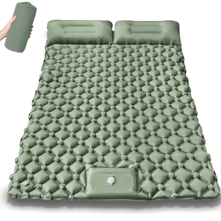 Person enjoying coffee on a dual camping air bed. Comfortable outdoor gear & adventure ready travel mattress.