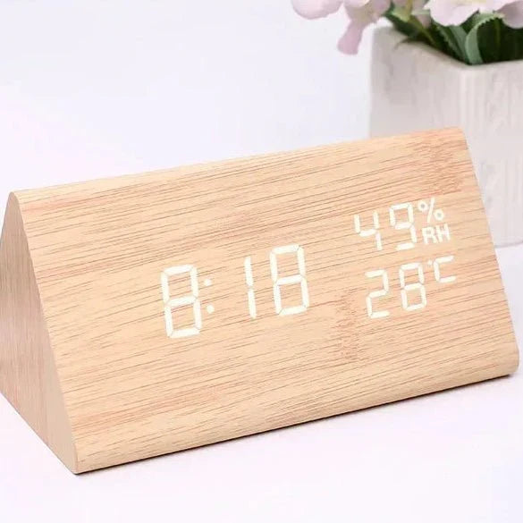 Close-up of wooden look LED alarm clock displaying time and temperature, highlighting digital clarity.