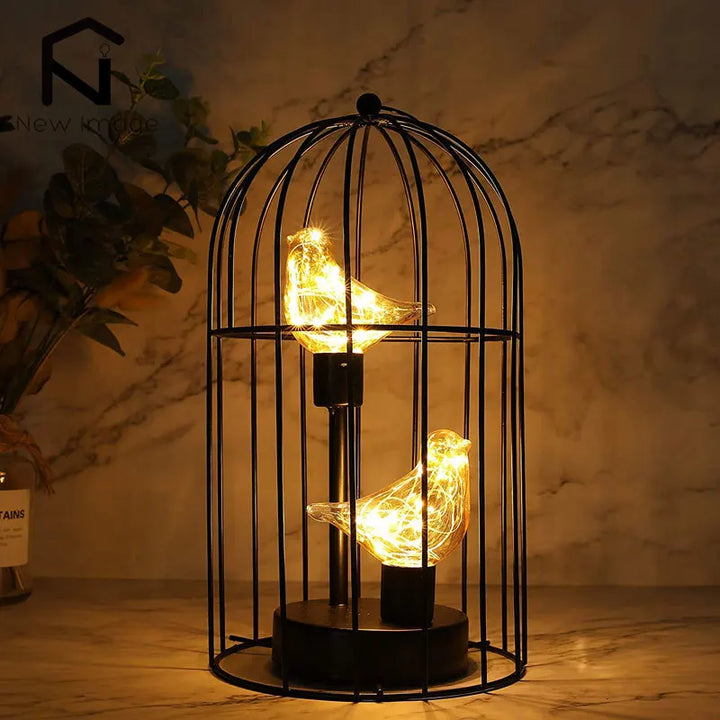 Stylish birdcage LED table lamp featuring delicate fairy lights, a charming cordless decor item.