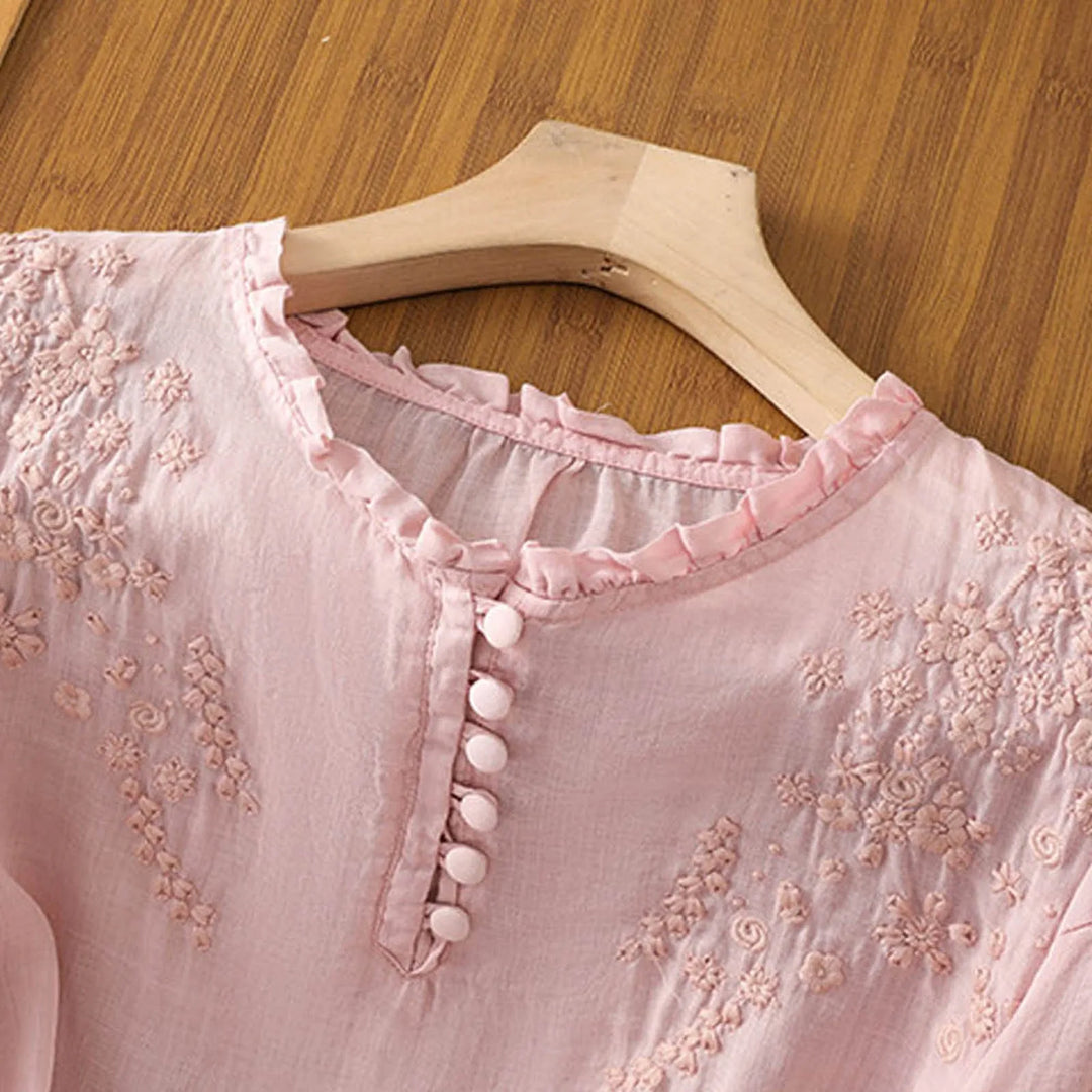Chic women's embroidered top with a relaxed fit and elbow sleeves, perfect for a stylish and versatile look.