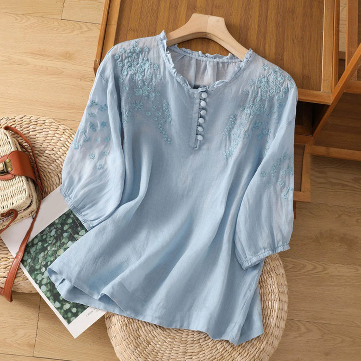 Elegant women's embroidered button-front blouse with a relaxed fit and elbow sleeves for chic casual style.