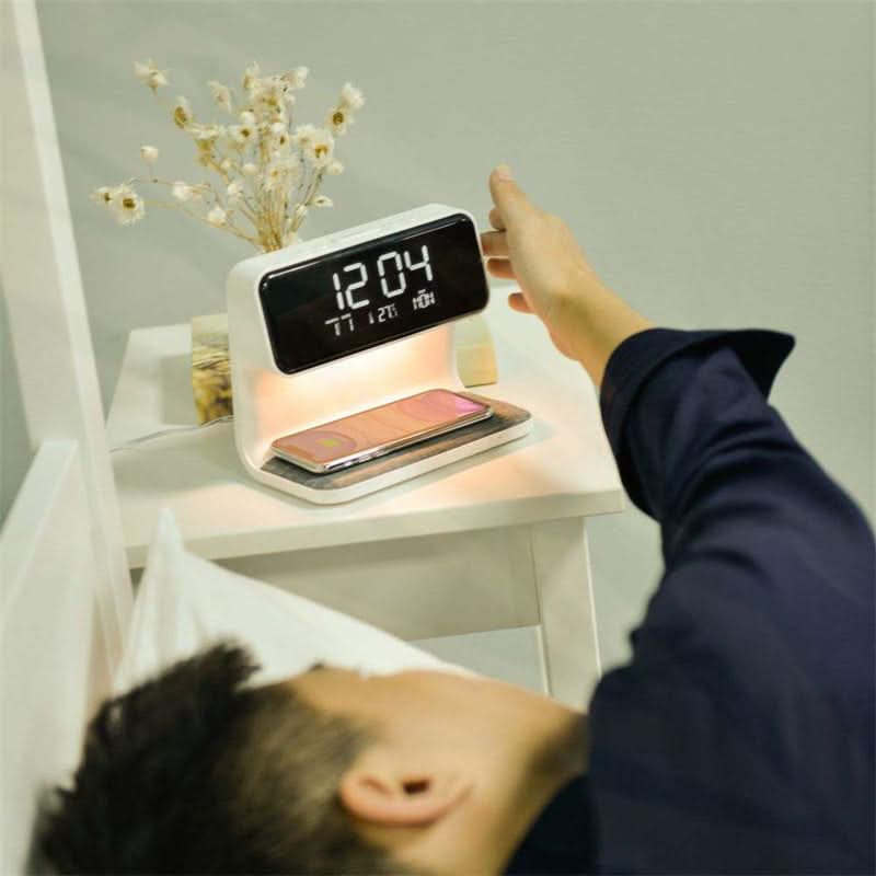 Multifunction bedside lamp with dimmable LED light, digital alarm clock & integrated wireless phone charger.