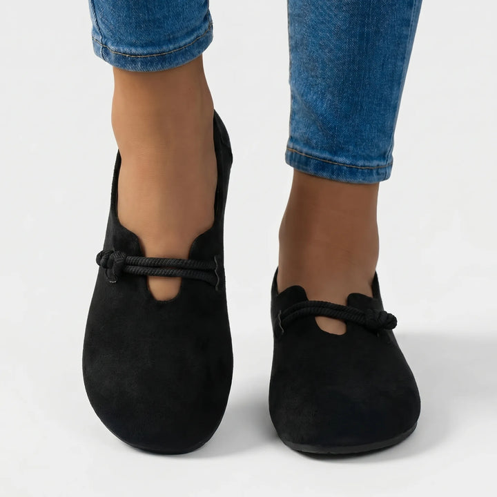 Stylish women's slip-on flats with decorative rope detail. Supportive sole offers all-day comfortable wear.