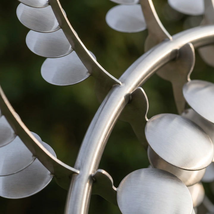 Large weather-resistant kinetic metal wind spinner with dynamic blades and sturdy ground stake.