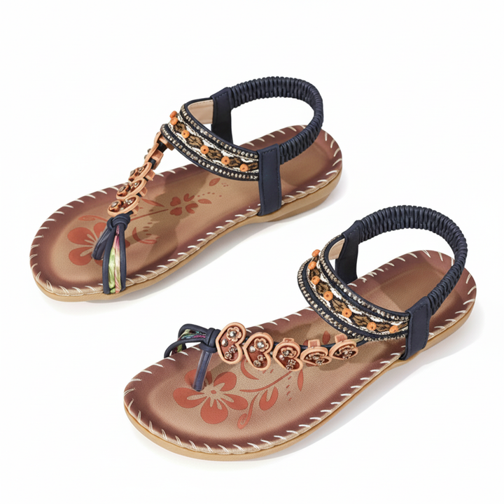 Pair of women's flat bohemian thong sandals with floral accents & an ankle strap, ready for summer casual wear.