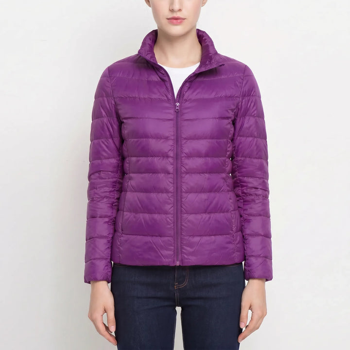 Women's lightweight quilted puffer jacket. A fitted, warm coat for chic autumn layering.