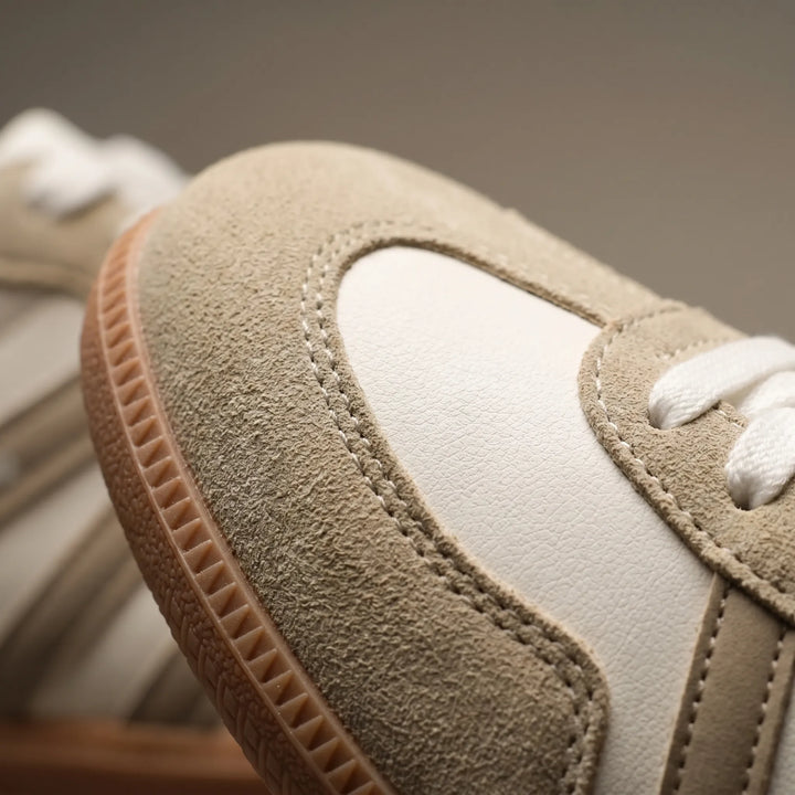 Stylish women's retro sneakers with classic stripes and secure lace-up closure, perfect for walking.