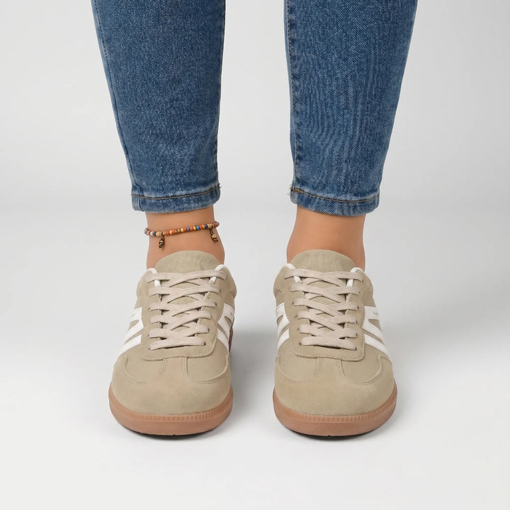 Women's retro-style trainers featuring vibrant stripes and secure laces for casual comfort.