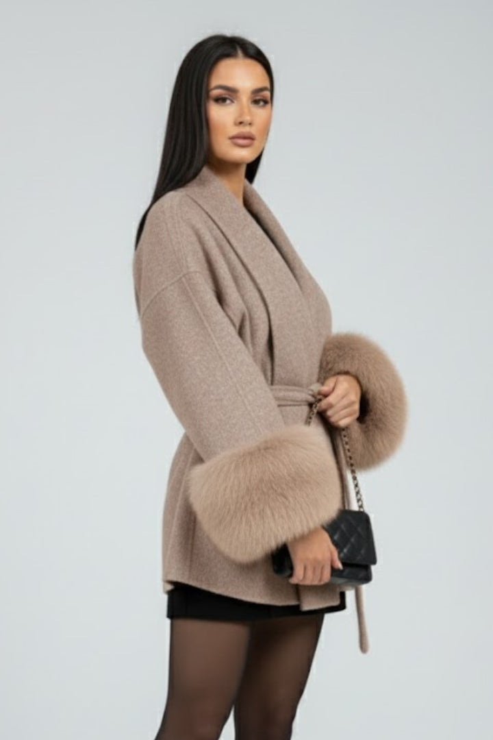 Chic women's long winter coat. Full length, belted for a flattering fit, featuring elegant faux fur cuffs.
