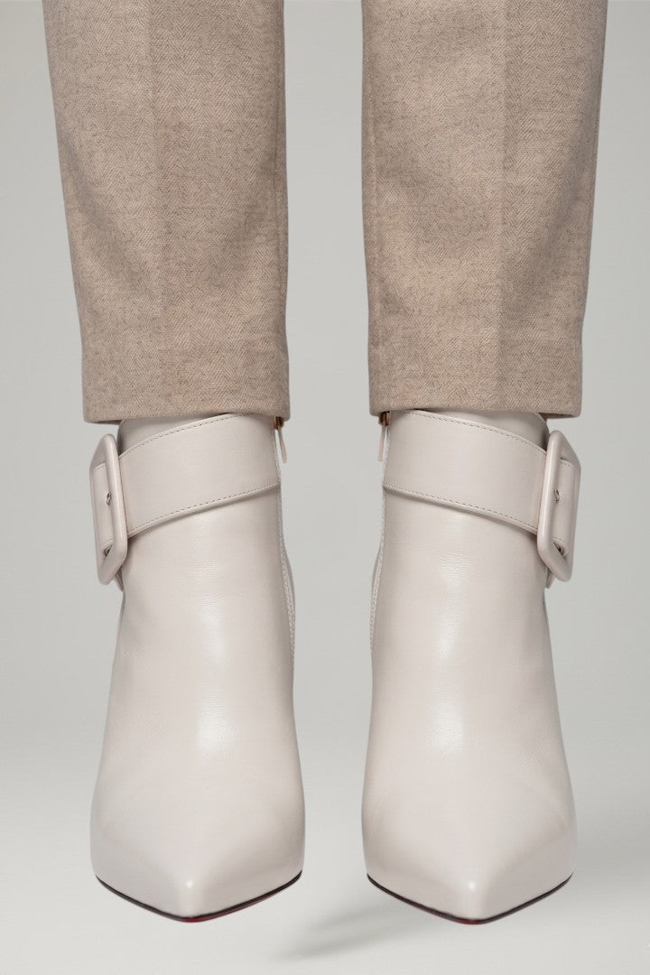 Chic beige women's ankle boots, featuring a side buckle and zip, ideal for versatile everyday wear.