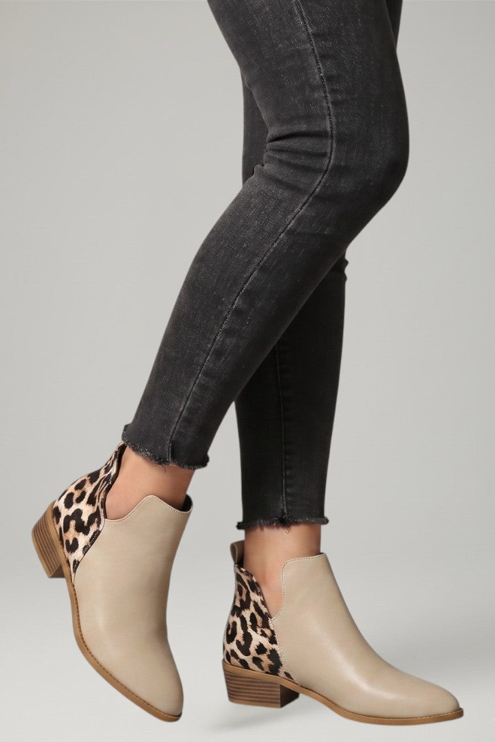 Versatile women's low heel ankle boots with a stylish side zipper, great for office or casual outings.