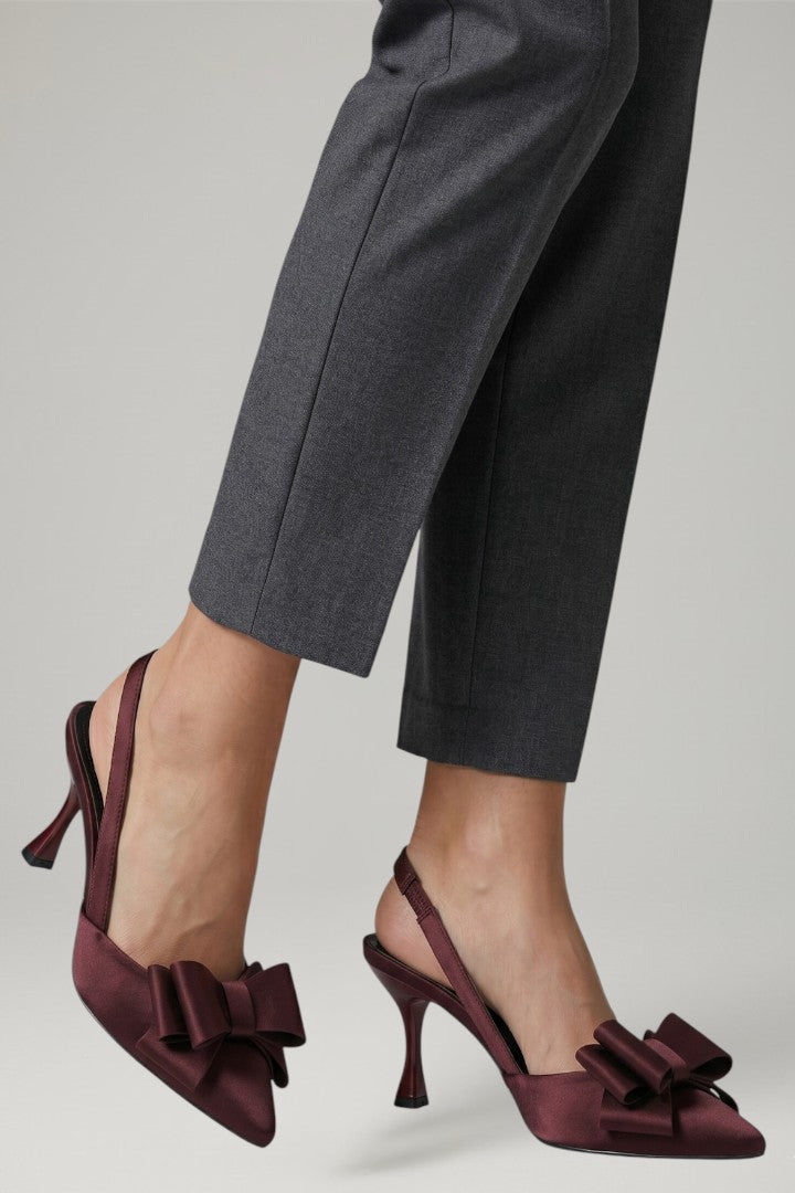 Chic women's pointed toe stiletto heels with elegant bow detail, offering a sophisticated formal look.