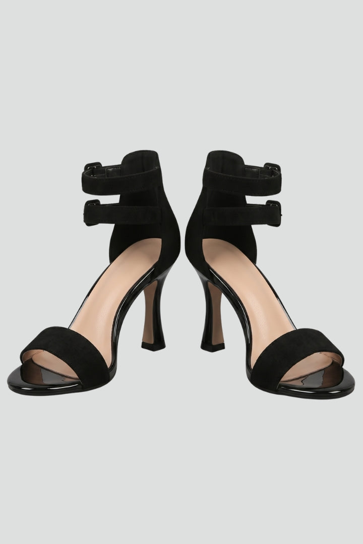 Women's chic black open-toe stiletto sandals with elegant ankle strap for party or formal evening wear.