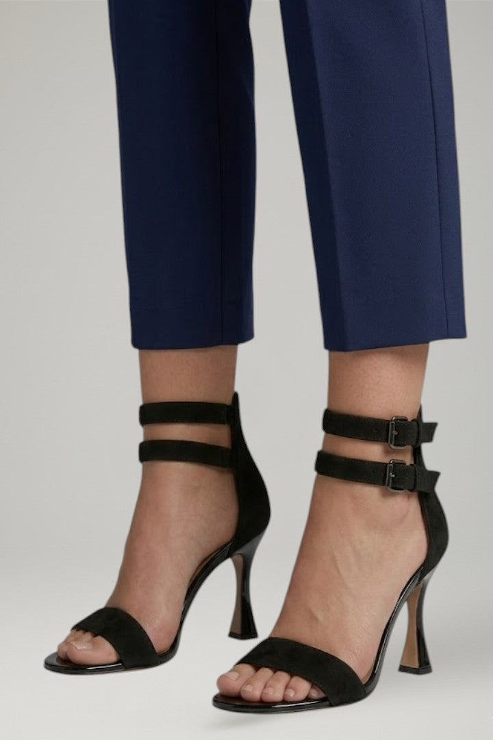 Side view of women's sleek black open-toe stiletto sandals, highlighting the elegant ankle strap design.