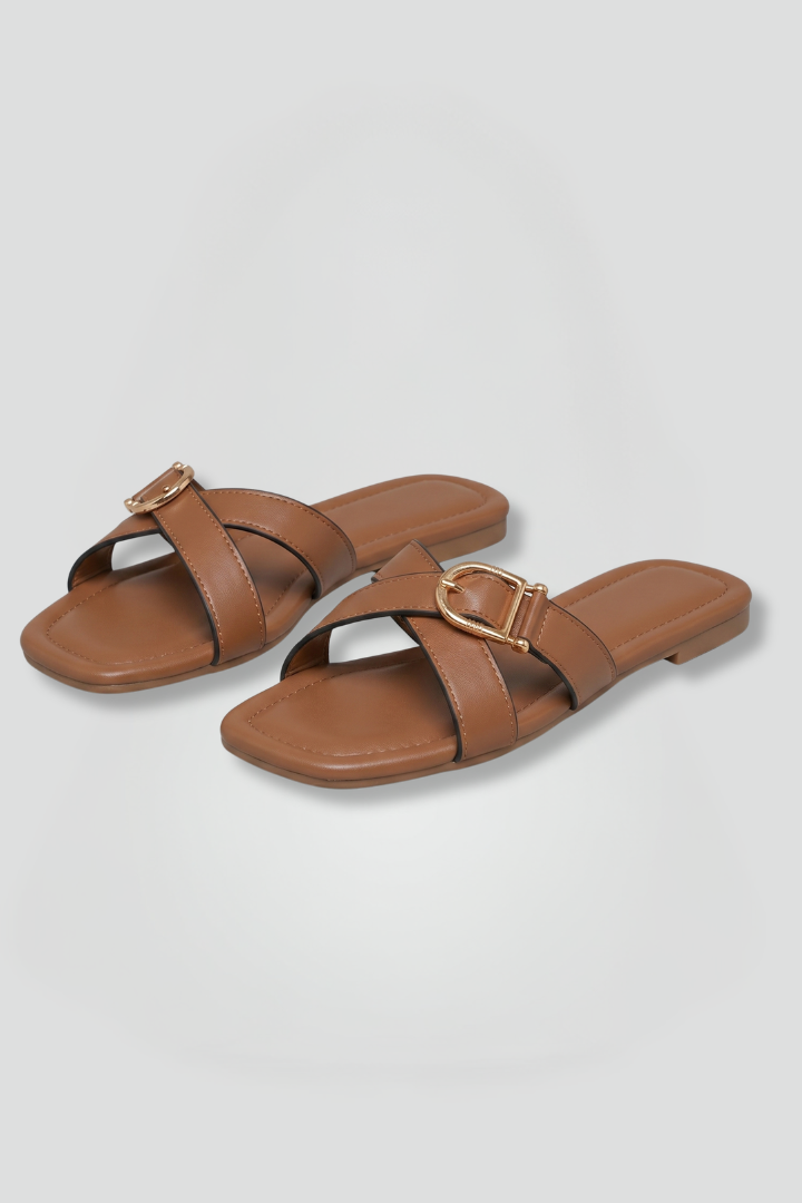 Women's chic slip-on sandals with stylish criss-cross straps, perfect for casual summer comfort.