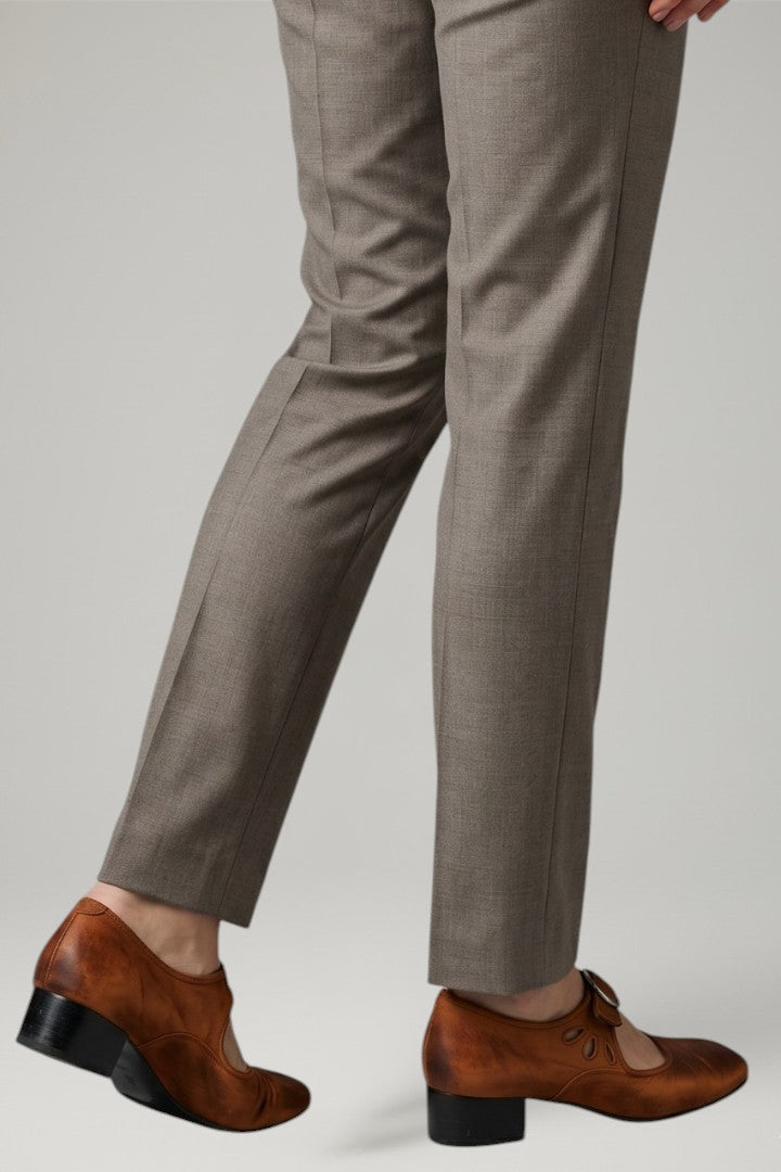 Close-up of polished buckle on women's low heel shoes, highlighting elegant detail & comfortable design.