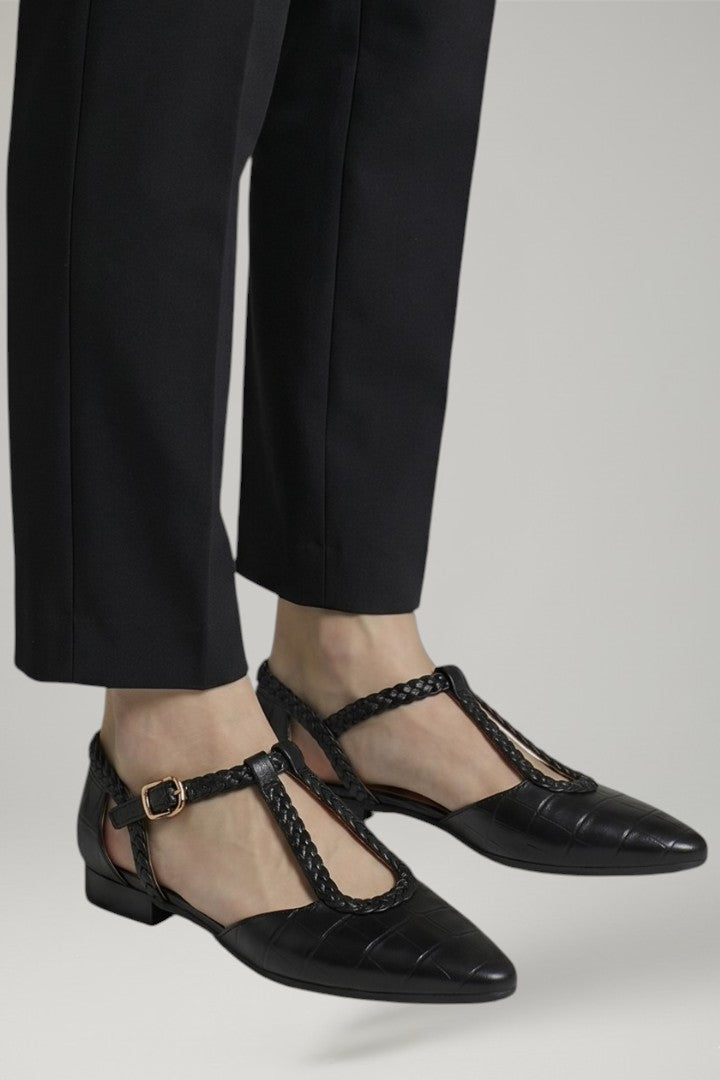 Brown women's T-strap flats featuring an adjustable buckle for a secure, comfortable, and elegant fit.