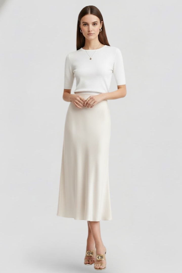 Flowing white midi skirt for women, high waist & elegant drape. Versatile for modern fashion.